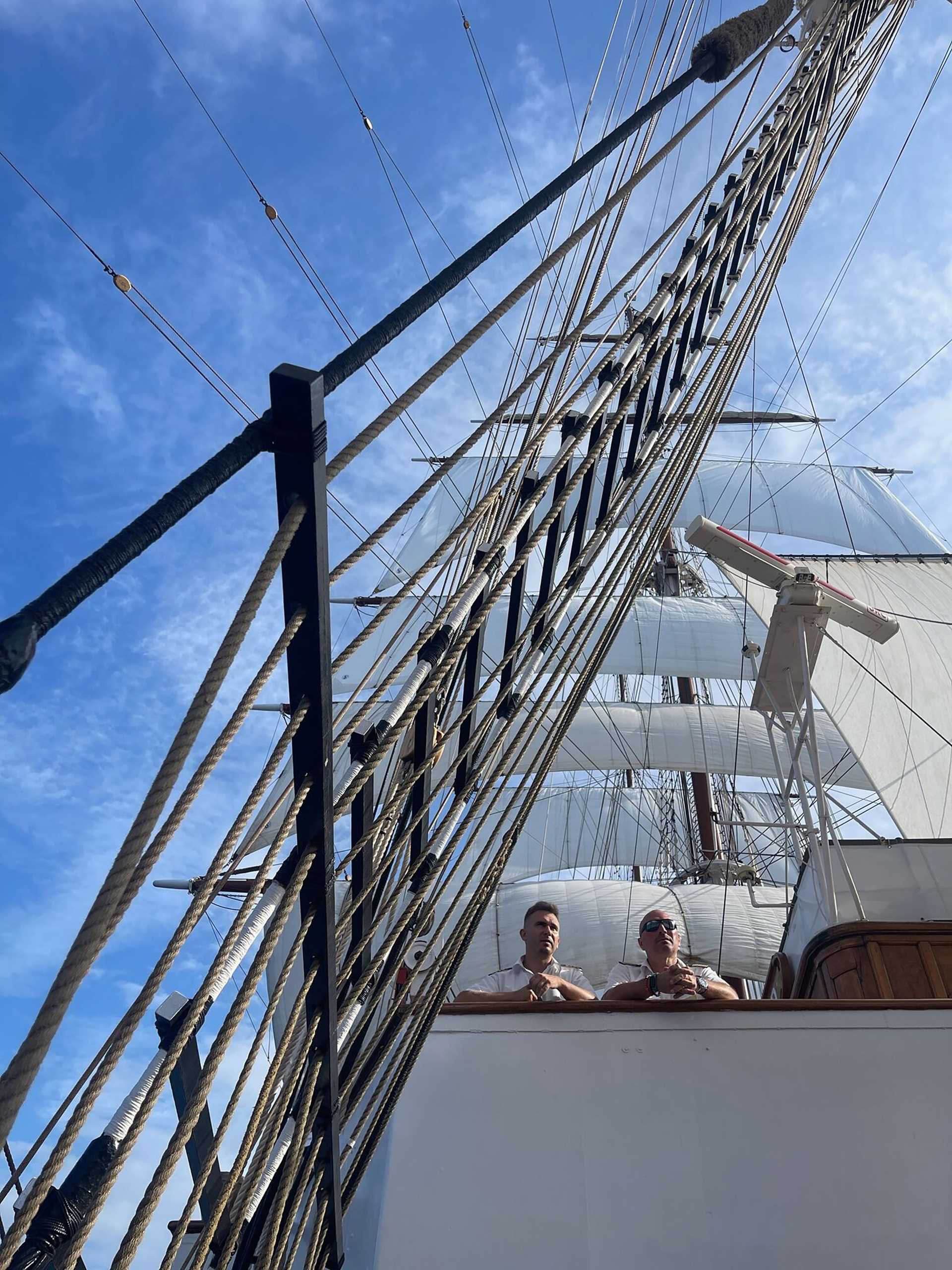 crew looking down from the bridge of the Sea Cloud