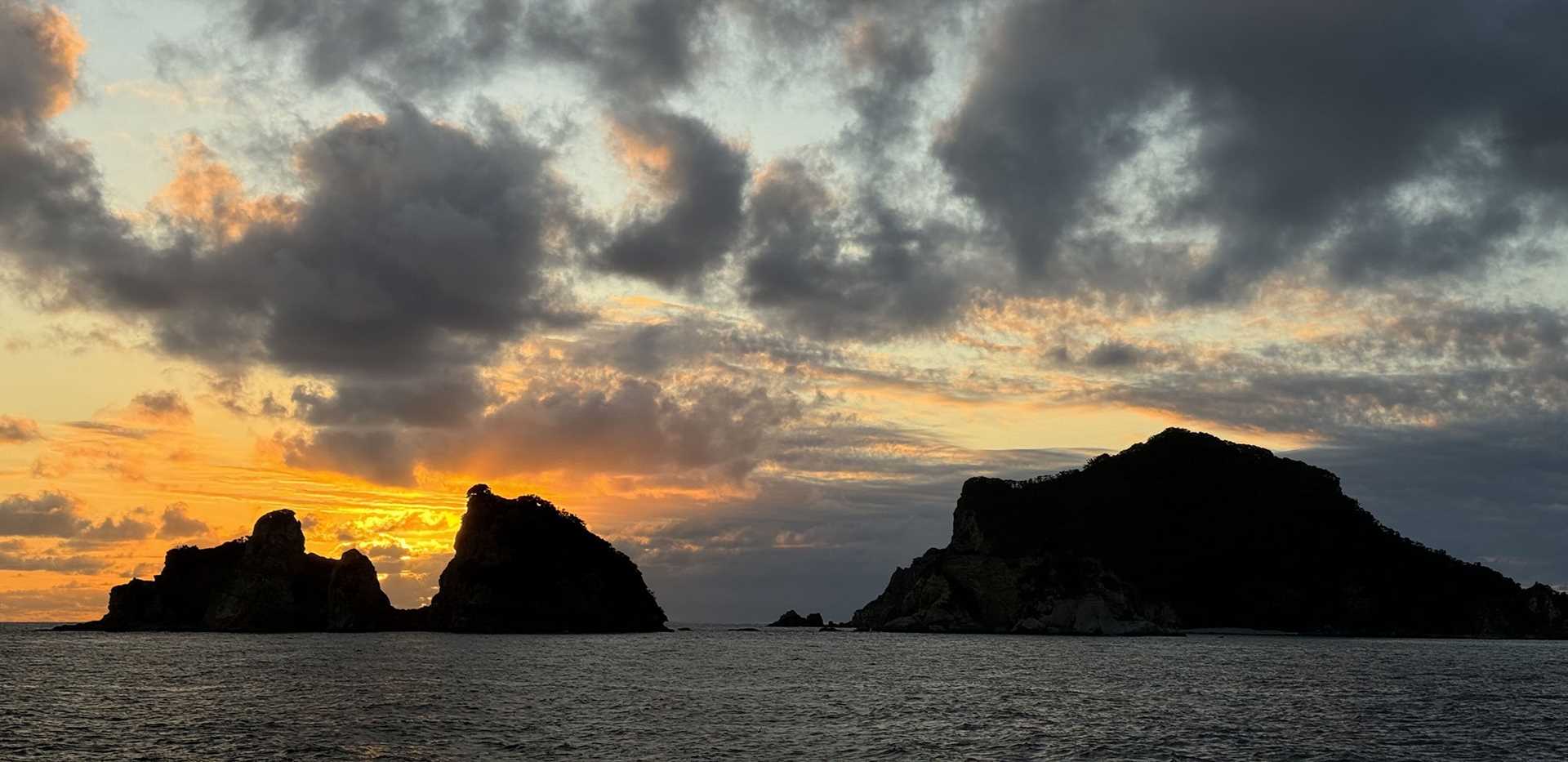 sunrise against ocean and rocks