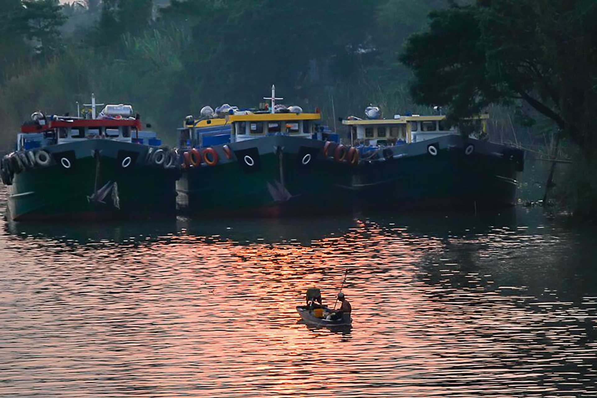 fishing boats at sunset