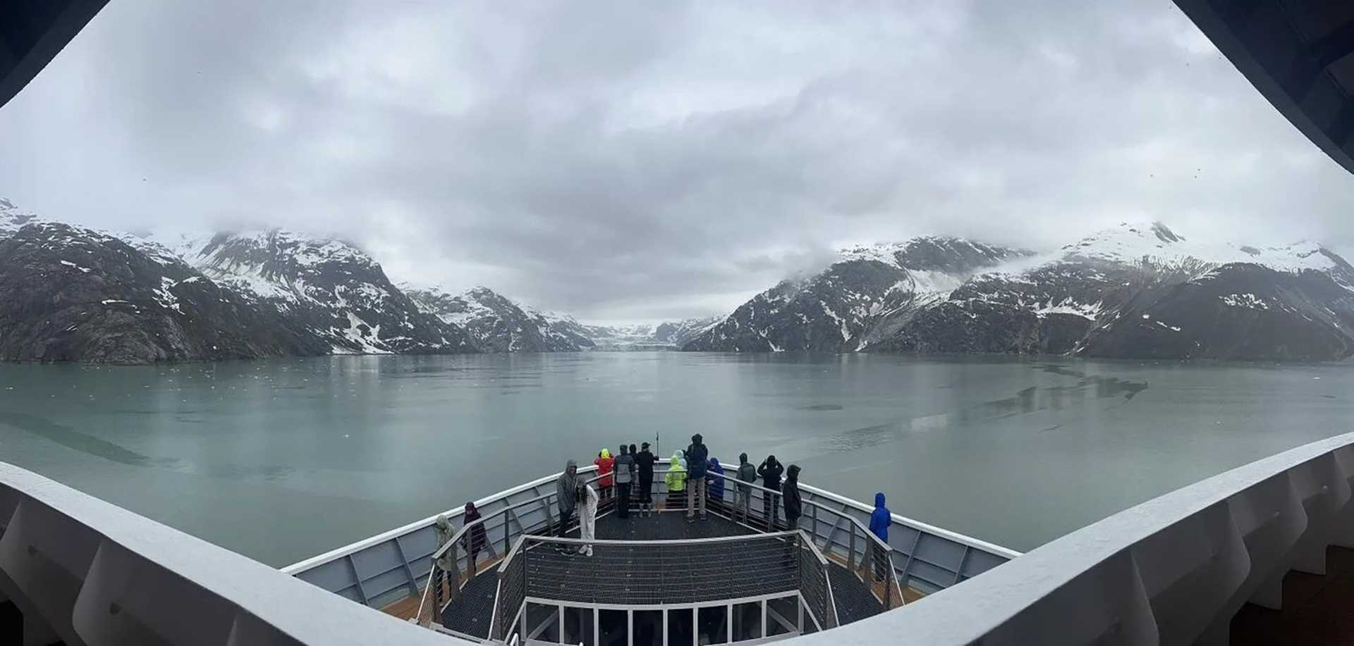 bow of ship with mountains in the background