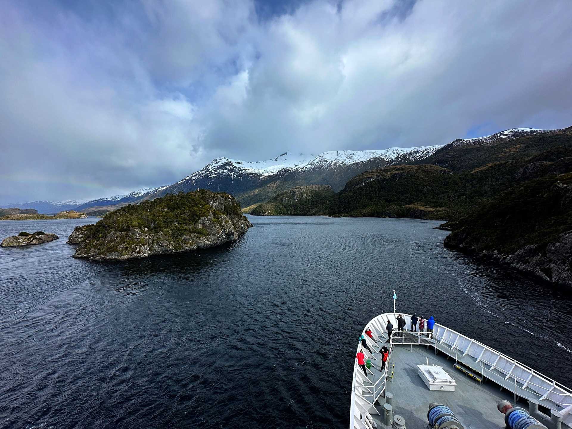 the bow of National Geographic Explorer in front of a landscape in Patagonia