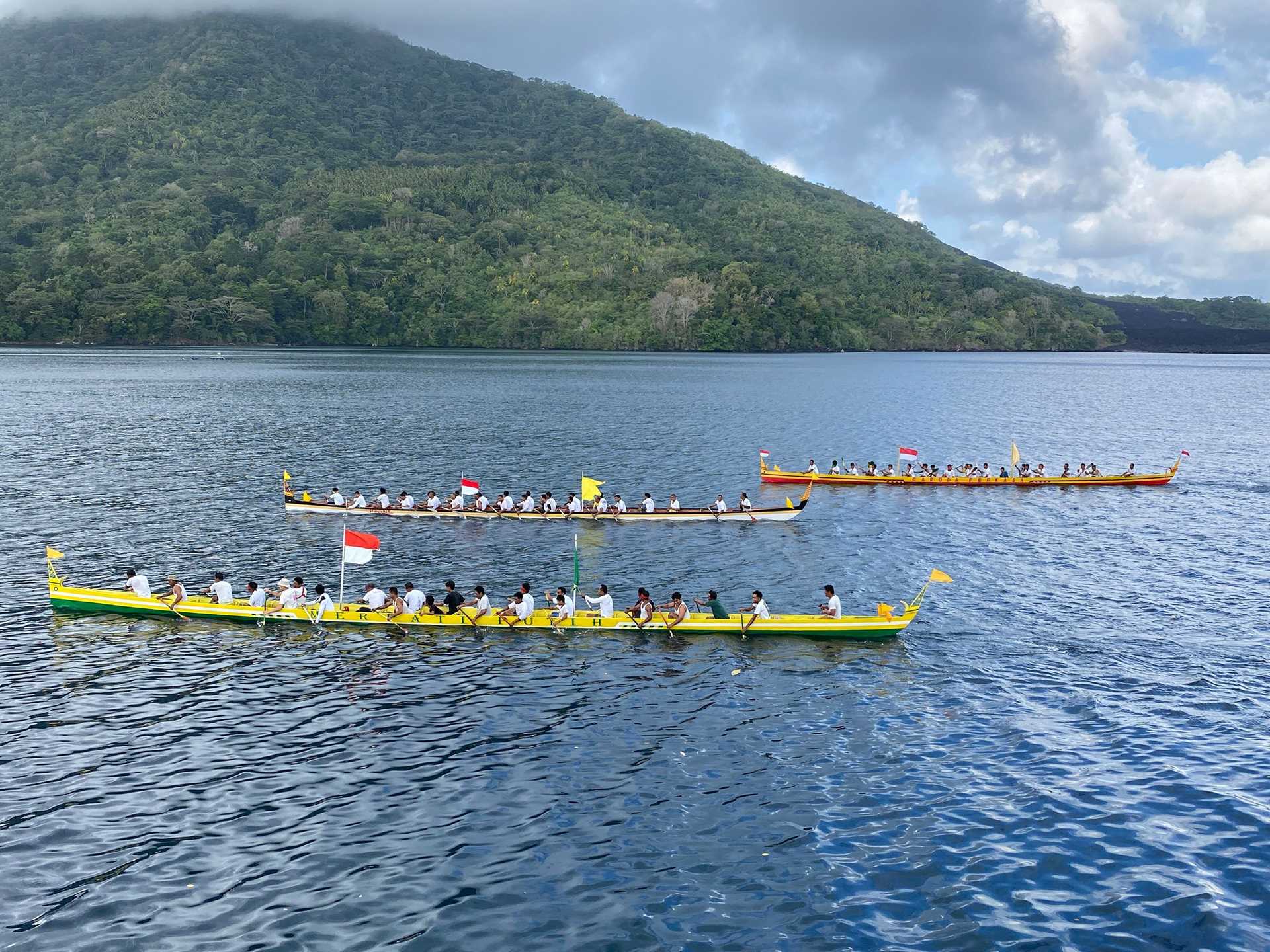 three long bright yellow canoes