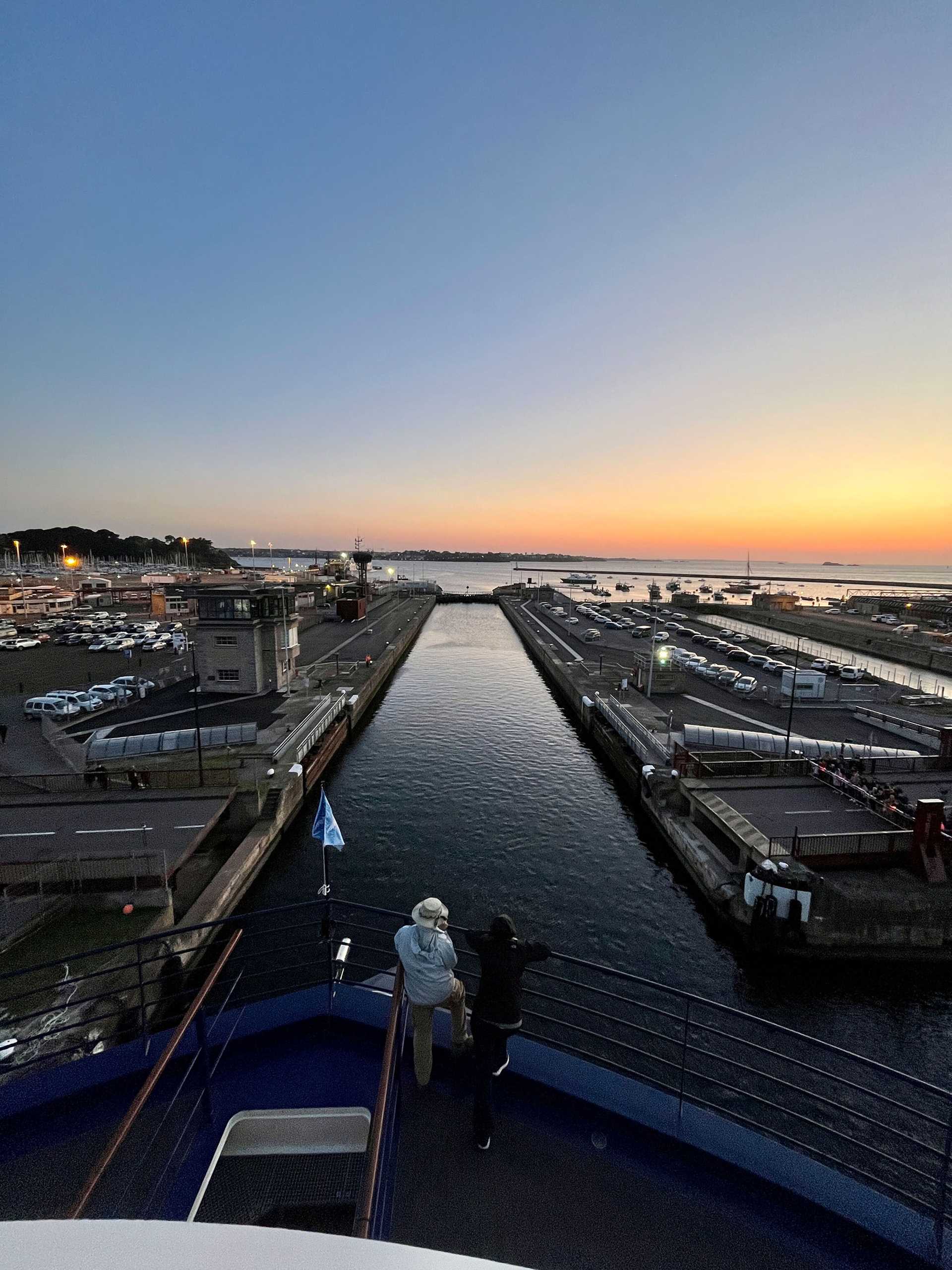 bow of National Geographic Resolution going through a lock at sunset